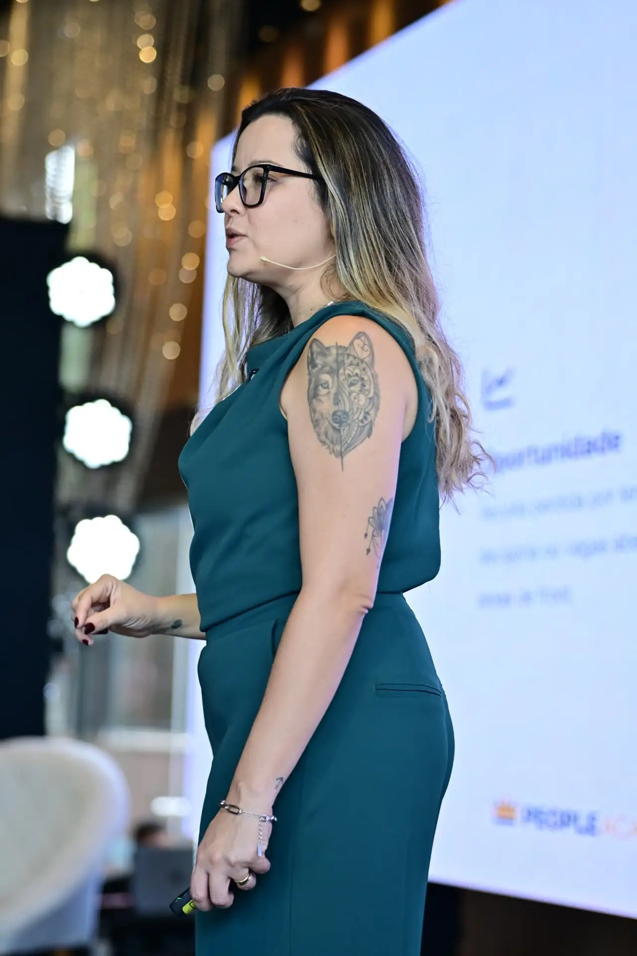 Jessica Martins conduzindo a formação Liderança Antifrágil no palco